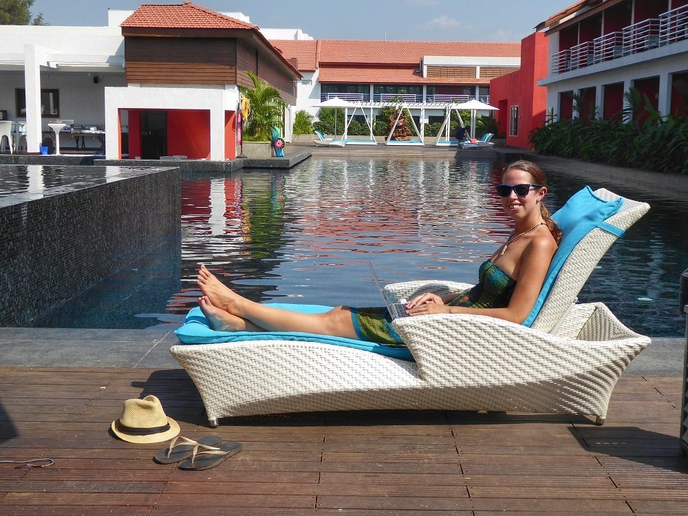 digital nomad working by the pool