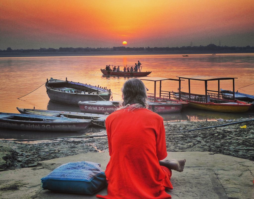 sadhu on the banks of the ganges at sunrise